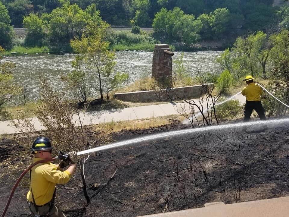 Forest firefighters imopping up a burn area of the Grizzly Creek Fire