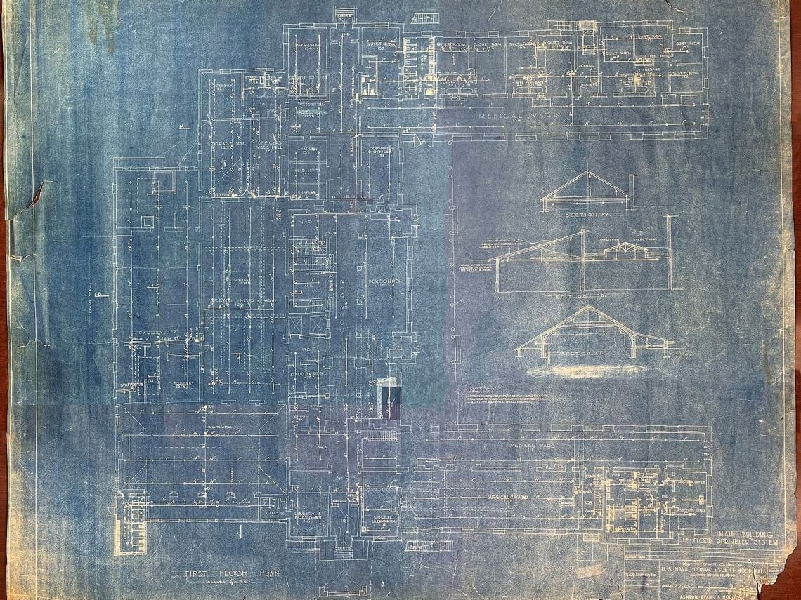 A faded architectural blueprint on aged paper, reminiscent of naval history, showing detailed floor plans and elevation views of a building. The design includes various measurements and technical annotations, imparting a vintage and historical appearance.