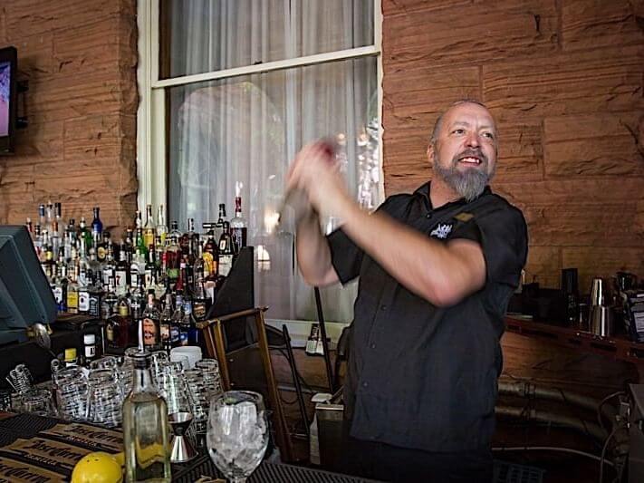 Bartender shaking a cocktail shaker at Hotel Colorado