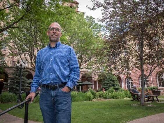 Craig Melville standing near a railing at Hotel Colorado