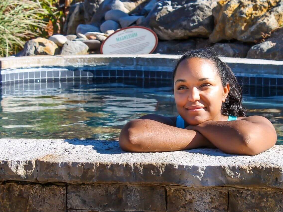 A women relaxing in a hot spring pool at Iron Mountain Hot Springs in Glenwood Springs, CO