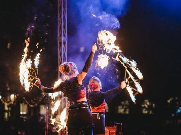 Two performers twirl flaming torches at Hotel Colorado