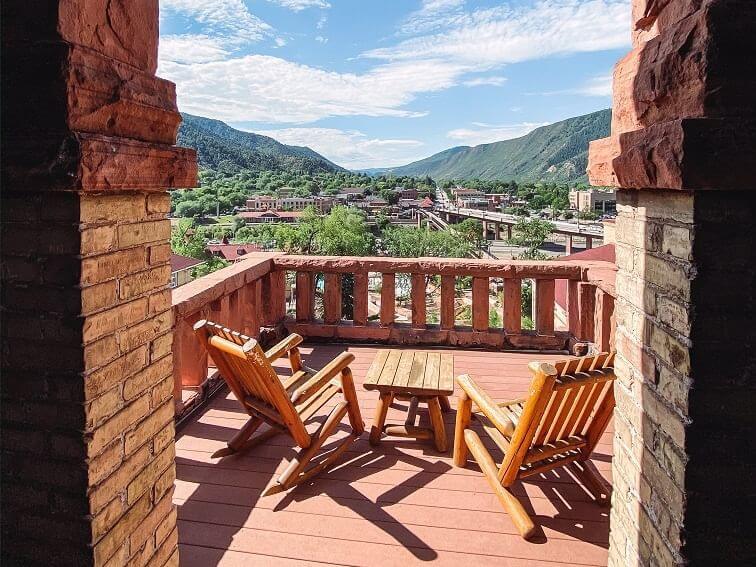 A scenic view from a rustic balcony overlooking Glenwood Springs at Hotel Colorado
