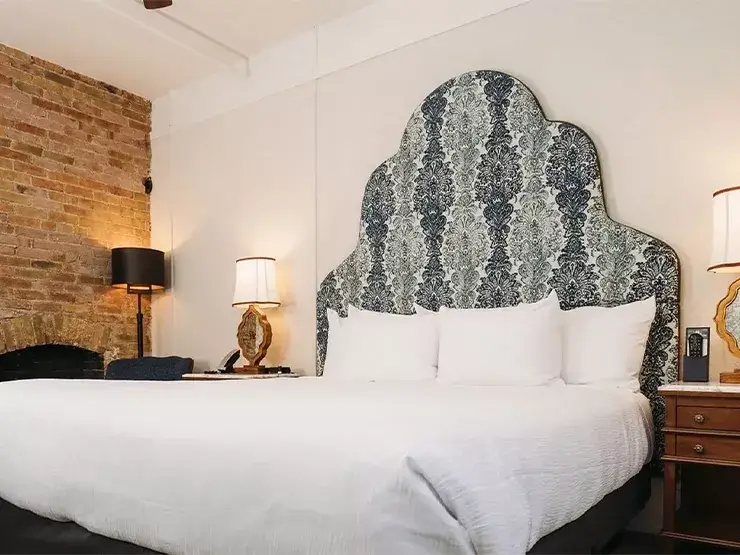 King bed with white bedding at Hotel Colorado