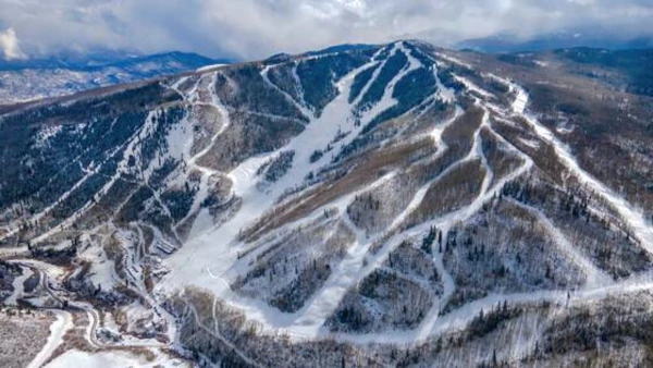 Aerial view of a snow-covered Sunlight Mountain with winding ski trails