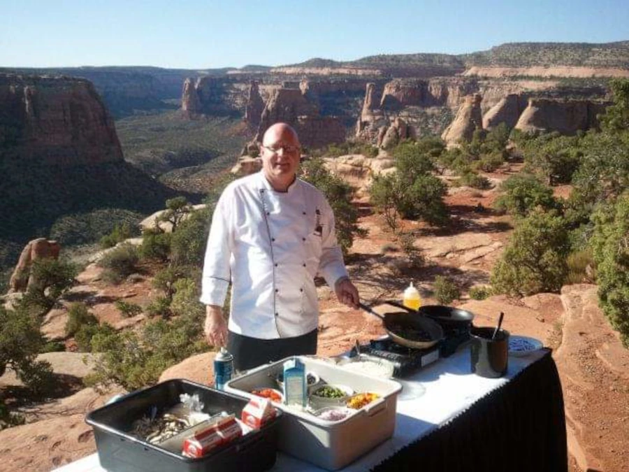 Chef Terry Allen cooking with beautiful canyon in background