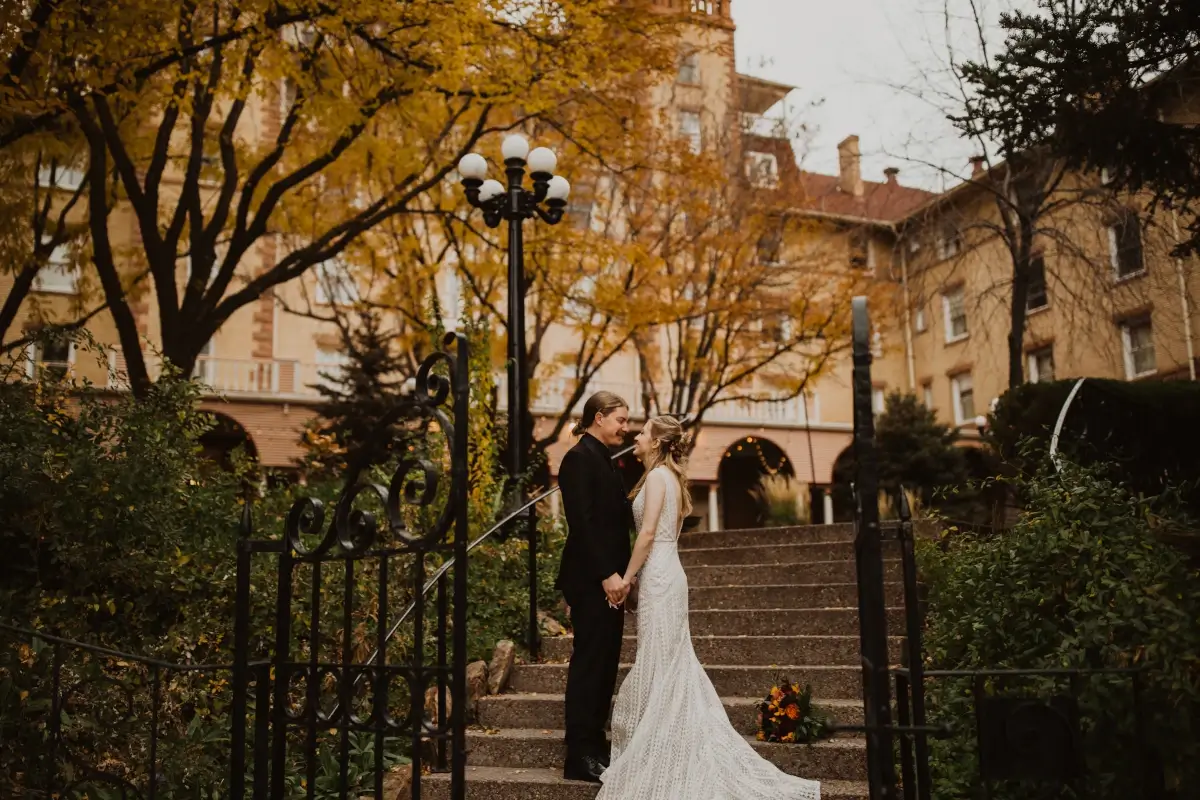 Bride and groom standing on steps at Hotel Colorado