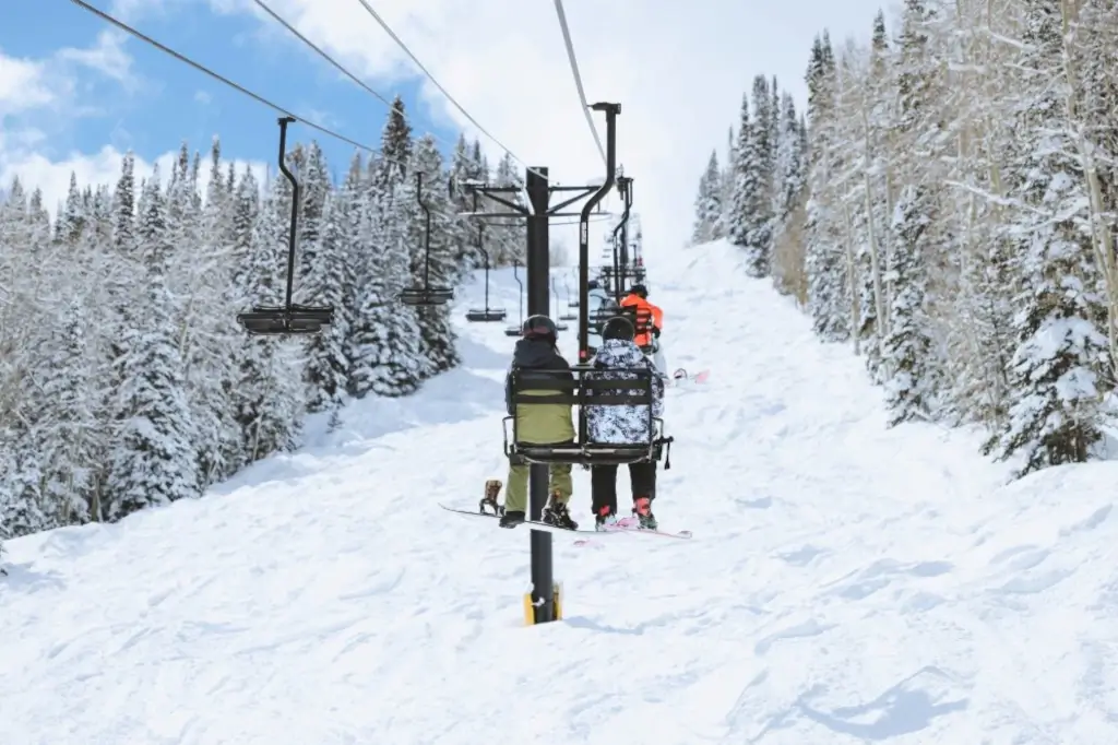 Skiers gracefully ascend a chairlift up Sunlight Mountain Resort